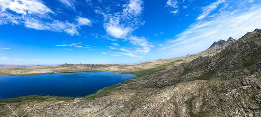 Beautiful summer steppe landscape and Ayr (Monastyri) Lake, located in stone mountains 