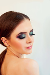 Obraz premium Beautiful model girl with Fashion Luxury Makeup, long eyelashes, perfect skin facial make-up. Beauty Brunette model woman holiday make up close up. Eyelash extensions, false eyelashes. 