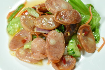 spicy Chinese pork sausage with vegetable Thai salad on plate