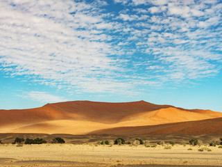 Big clouds over the salt pan Sossuvlei. Namib Naukluft National Park. Sand dunes in the pan of Sossusvlei. Namibia. Africa.
