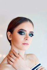 Obraz premium Beautiful model girl with Fashion Luxury Makeup, long eyelashes, perfect skin facial make-up. Beauty Brunette model woman holiday make up close up. Eyelash extensions, false eyelashes. 