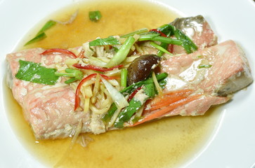 steamed salmon with soy sauce topping slice ginger on plate
