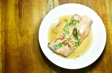 steamed salmon with soy sauce topping slice ginger on plate