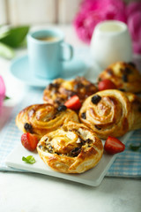 Sweet rolled buns with custard and raisins