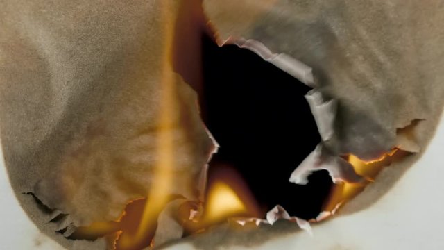 Burning paper through the center on a black background