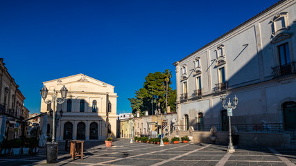 Fototapeta premium Municipal Theater Saverio Mercadante, 1868. Facade with two galleries. Ancient building, balconies, iron railings, liberty style street lamps. In piazza Giacomo Matteotti, in Cerignola, Puglia, Italy.