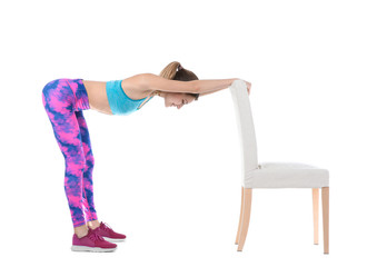 Young woman exercising with chair on white background. Home fitness