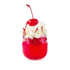 Strawberry jelly in a glass with cherries and whipped cream isolated on white background