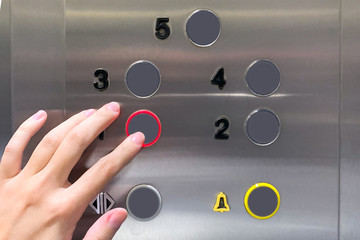 Woman's hand pressed the lift button