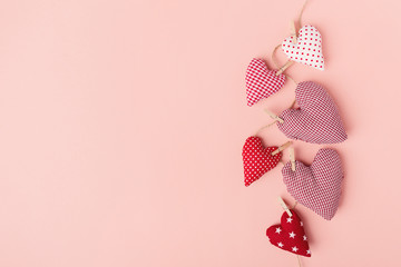 Textile valentines day hearts on pink