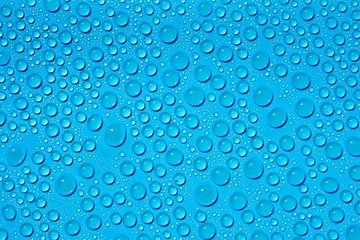 closeup drops water on blue background