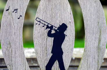 Trombonist design on a garden bench