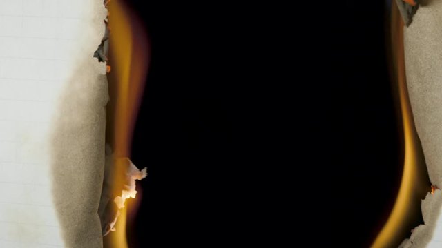 Burning paper through the center on a black background