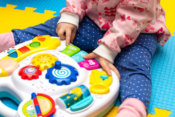 musical development for children. little girl playing educational toy