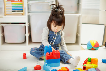 toddler baby girl play toy blocks at home