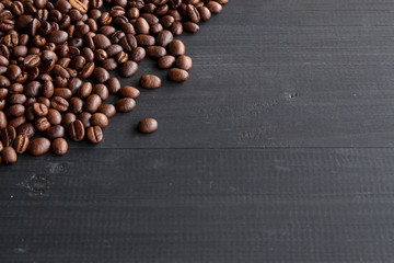 coffee beans on old wooden with soft-focus and over light in the background