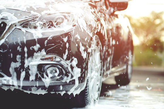 Outdoor car wash with foam soap.