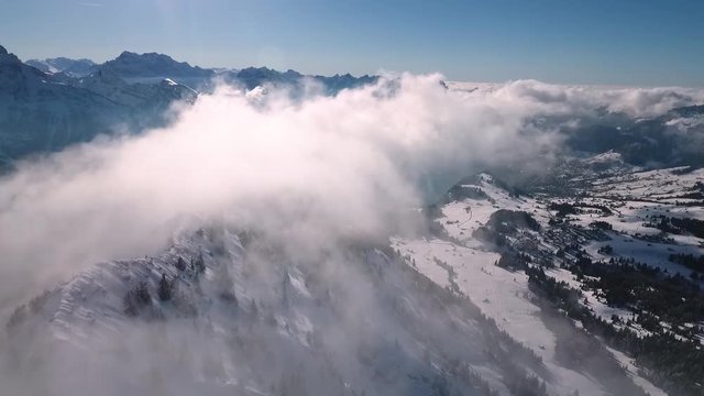 a drone flight in the Swiss mountains through the fog
