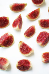 Fresh fig pieces isolated on white background in selective focus
