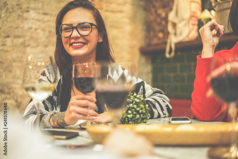 Wall mural happy friends drinking wine inside vintage trendy bar