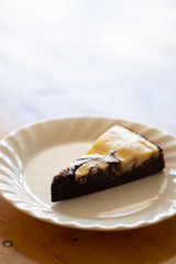 Slice of baked brownie cheesecake
