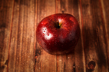 Red apple on wooden background