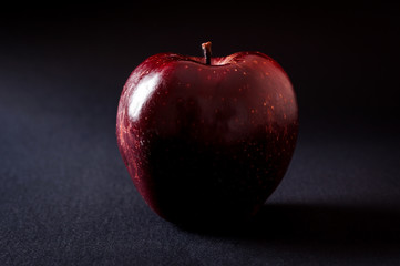 Red apple on black background