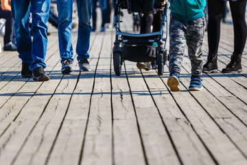 cropped image of family walking with baby carriage