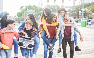 Happy friends having fun walking on city street center outdoor