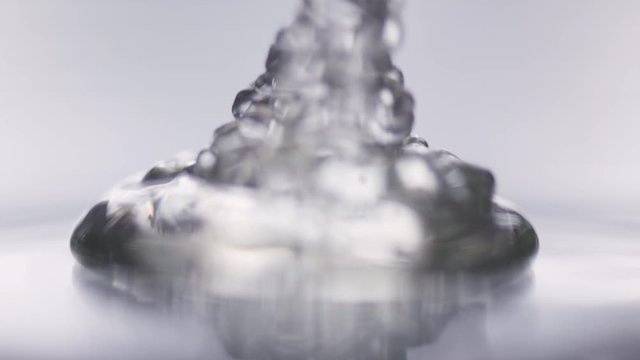 Macro shot of transparent gel accumulating on a glas plade