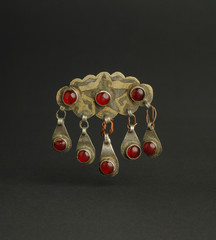 ancient antique brooch with stones on black background. Middle-Asian vintage jewelry