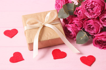 gift, flowers and hearts on a colored background. Background to Valentine's Day or Mother's Day. Holiday, give. International Women's Day.