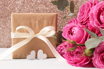 gift, flowers and hearts on a colored background. Background to Valentine's Day or Mother's Day. Holiday, give. International Women's Day.