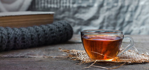 still life tea drinking in the living room a cup of tea with a kettle and a book on a wooden table, the concept of coziness