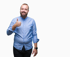 Young caucasian hipster man over isolated background doing happy thumbs up gesture with hand. Approving expression looking at the camera with showing success.