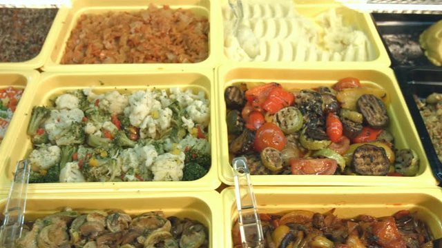 Side dishes in the supermarket.
Different side dishes are located on the showcase: steamed vegetables, sauteed rice, grilled vegetables, european pilaf, mushrooms, cabbage