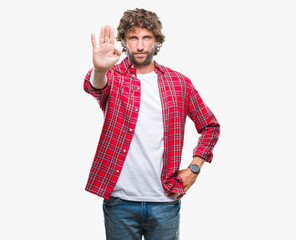 Handsome hispanic model man over isolated background doing stop sing with palm of the hand. Warning...