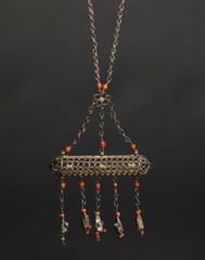 ancient antique pendant with stones on black background. Middle-Asian vintage jewelry