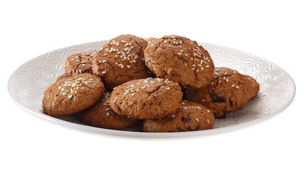 Homemade oatmeal cookies with nuts, chocolate chips and sesame. Isolated on white background.