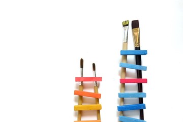 business, success, leadership, achievement and people concept .Concept of success and achieving your goal. - colorful ladder made of chalk with paintbrush. white background.