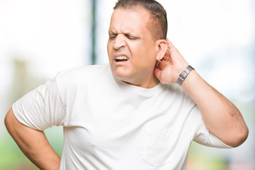 Middle age arab man wearig white t-shirt over isolated background Suffering of neck ache injury, touching neck with hand, muscular pain