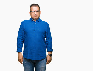 Middle age arab man wearing glasses over isolated background Relaxed with serious expression on face. Simple and natural looking at the camera.