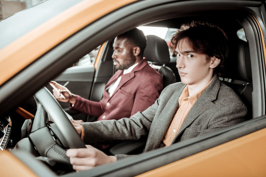 Dark-eyed Young Man Feeling Nervous While Driving For The First Time