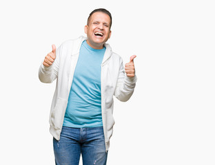 Middle age arab man wearing sweatshirt over isolated background success sign doing positive gesture with hand, thumbs up smiling and happy. Looking at the camera with cheerful expression