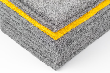 stack of gray and yellow terry towels, conceptual background