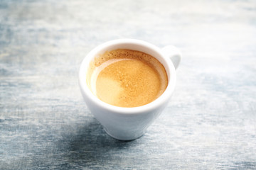 Cup of coffee on rustic wooden background. Copy space.