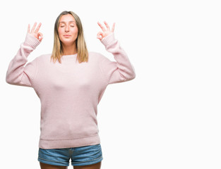 Young beautiful woman wearing winter sweater over isolated background relax and smiling with eyes closed doing meditation gesture with fingers. Yoga concept.