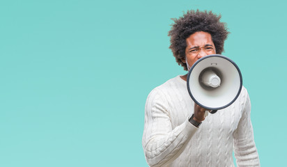 Young handsome afro american black man shouting through megaphone