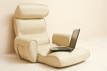 Laptop on a leather seated sofa,selective focus.