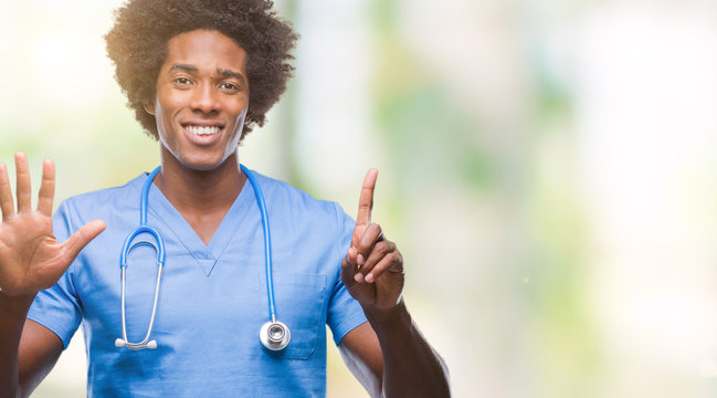 Afro american surgeon doctor man over isolated background showing and pointing up with fingers number six while smiling confident and happy.